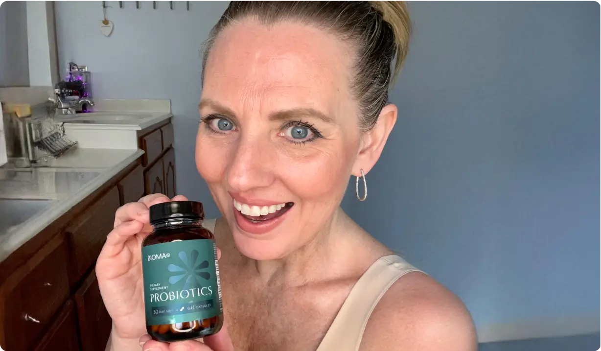 Happy Bioma Probiotics customer holding her bottle